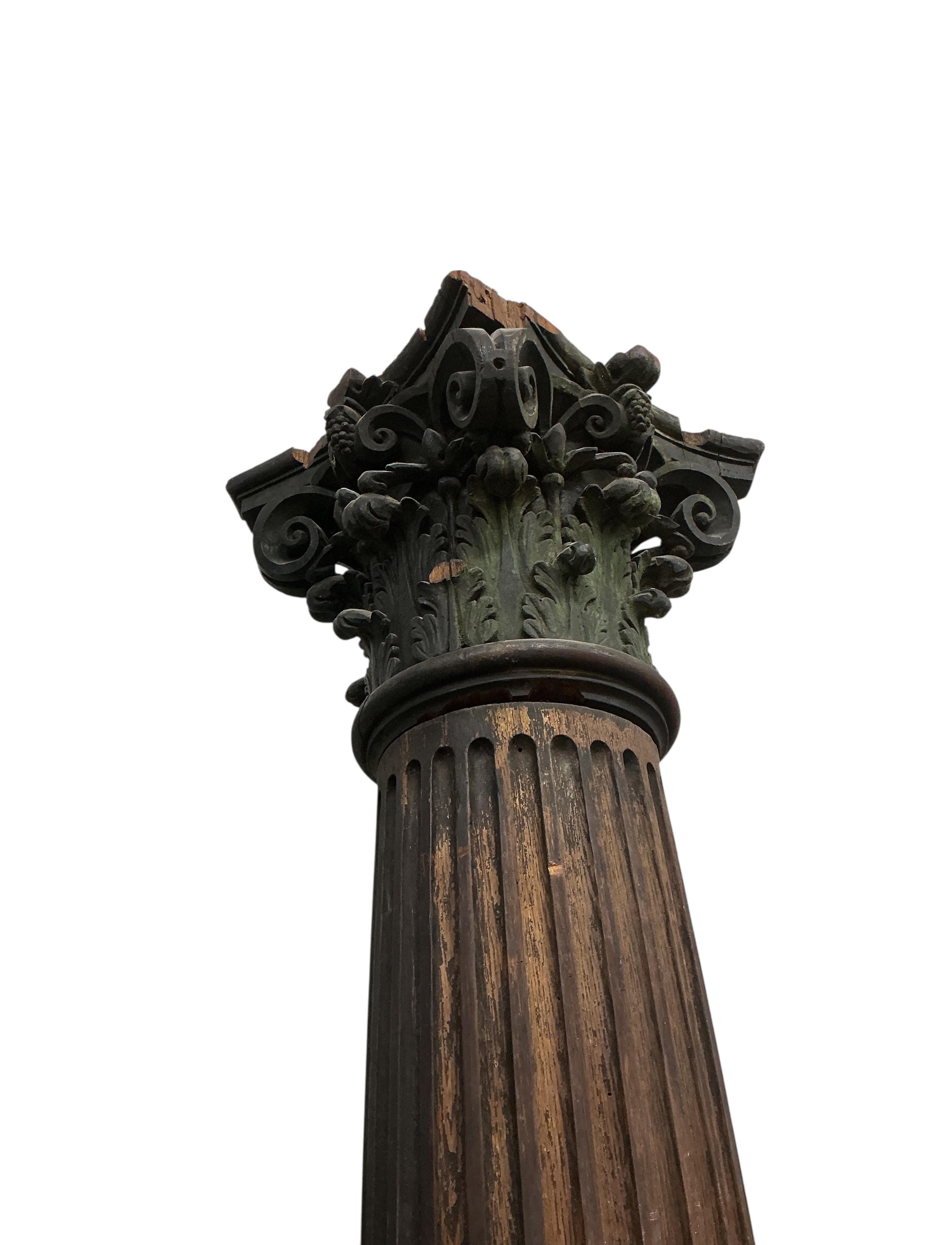 A pair of 17th century oak Corinthian columns, of large size, height 279cm, by repute from St Mary le Bow, designed by Christopher Wren